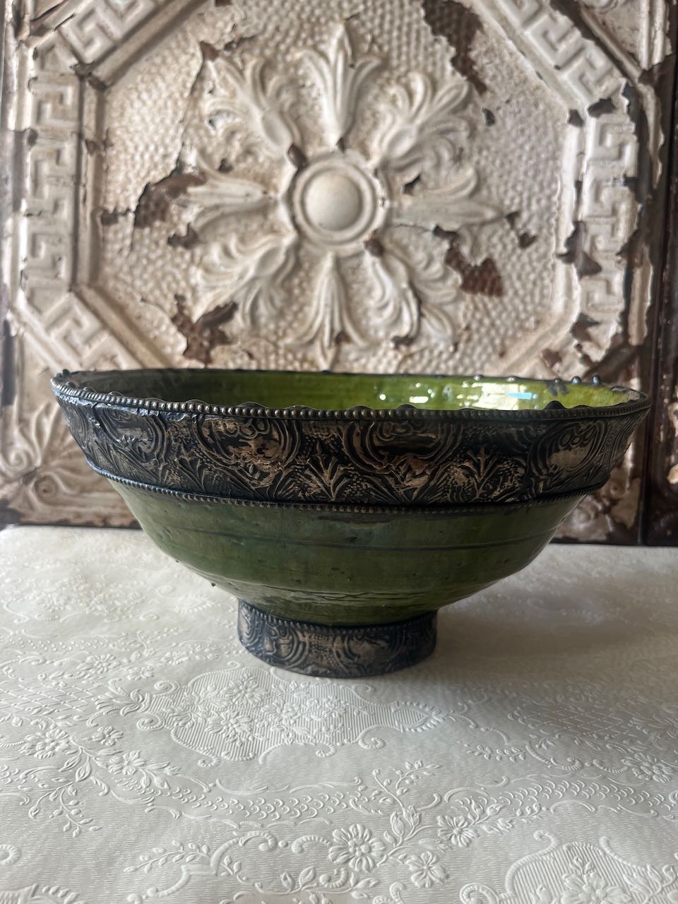 Authentic medium Tamegroute pottery bowl with rustic green glaze and decorative hand-stamped silver metal rim and base.
