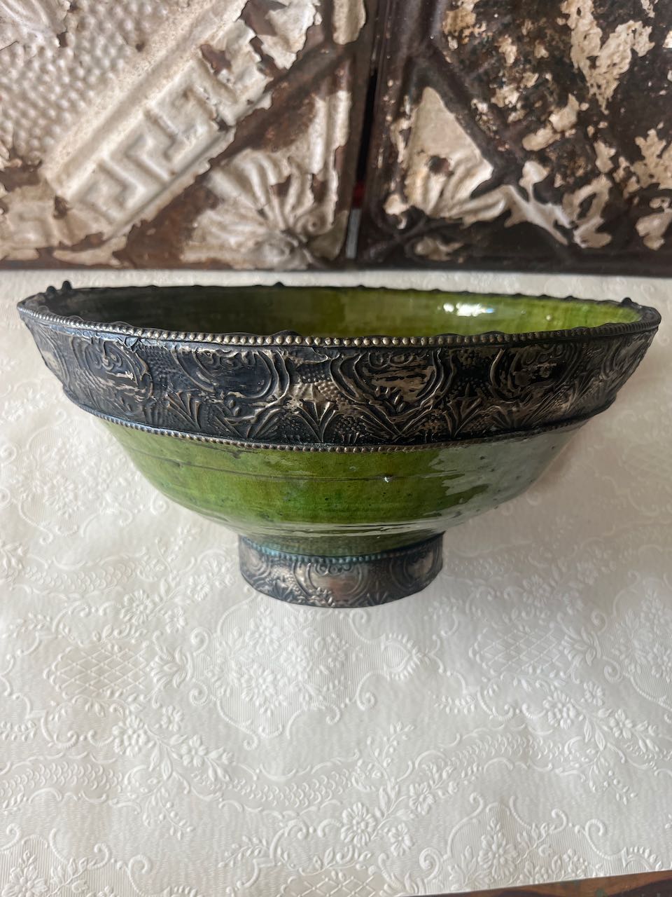 Authentic medium Tamegroute pottery bowl with rustic green glaze and decorative hand-stamped silver metal rim and base.