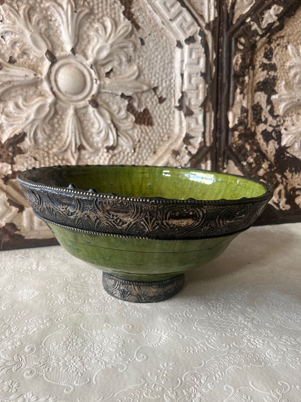 Authentic medium Tamegroute pottery bowl with rustic green glaze and decorative hand-stamped silver metal rim and base.