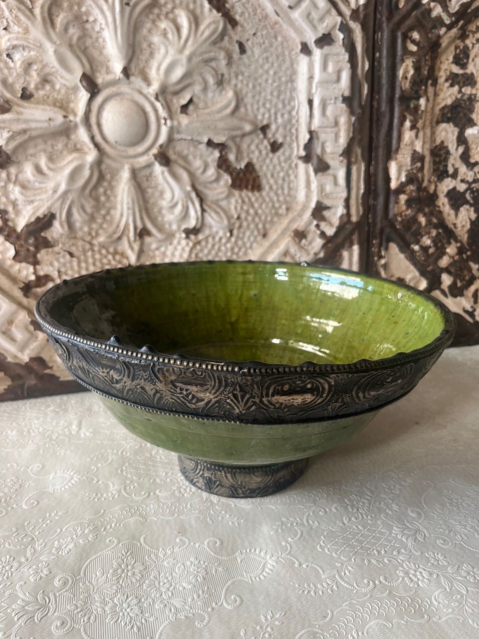Authentic medium Tamegroute pottery bowl with rustic green glaze and decorative hand-stamped silver metal rim and base.