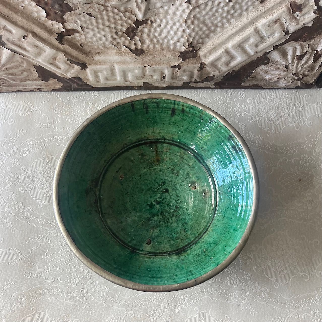 Authentic medium Tamegroute pottery bowl with rustic green glaze and decorative silver metal rim and base.