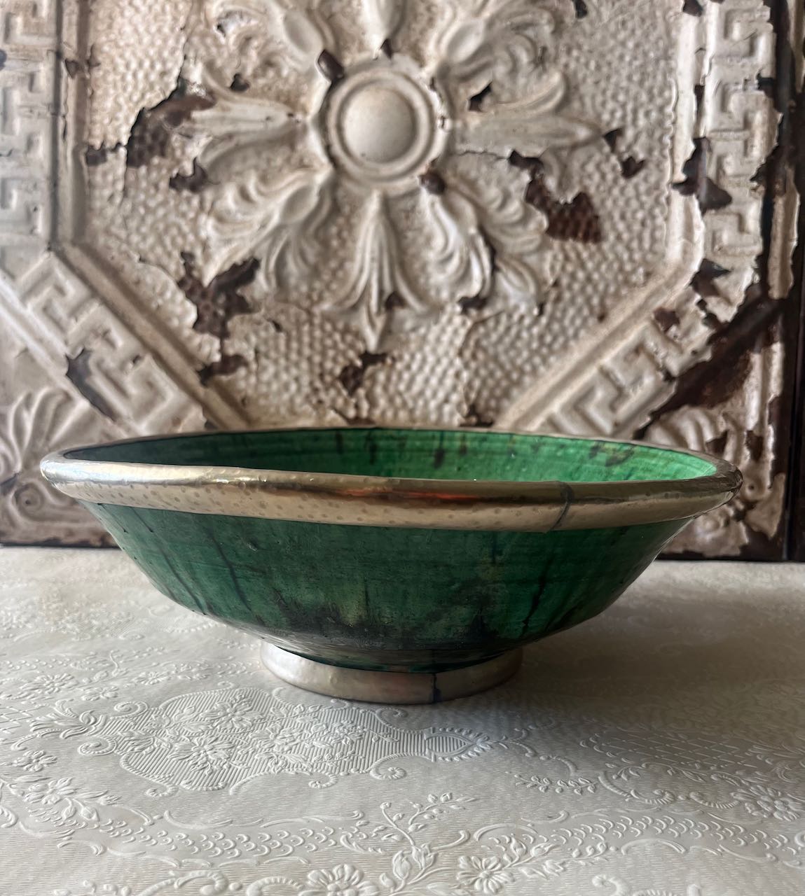 Authentic medium Tamegroute pottery bowl with rustic green glaze and decorative hand-stamped silver metal rim and base.