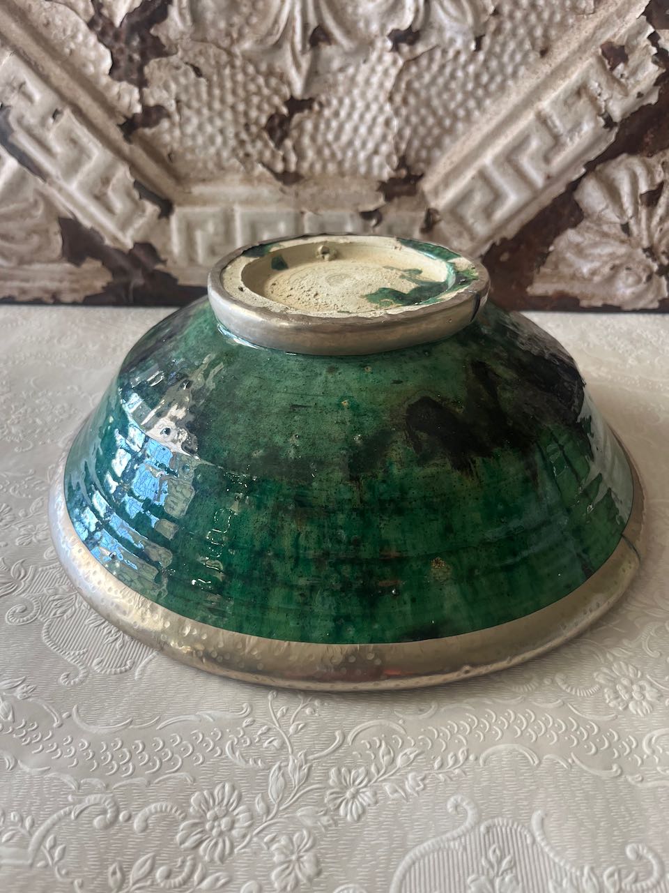 Authentic medium Tamegroute pottery bowl with rustic green glaze and decorative  silver metal rim and base.